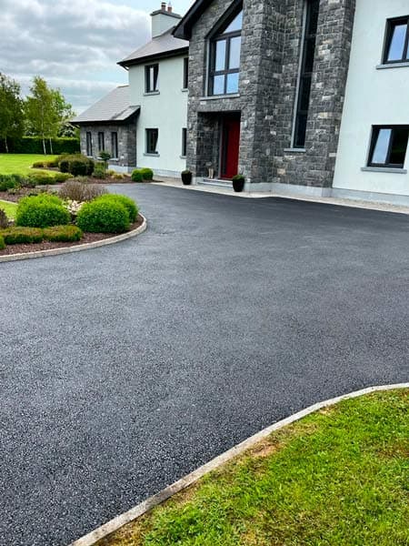 Tarmac driveway freshly sealed outside a house