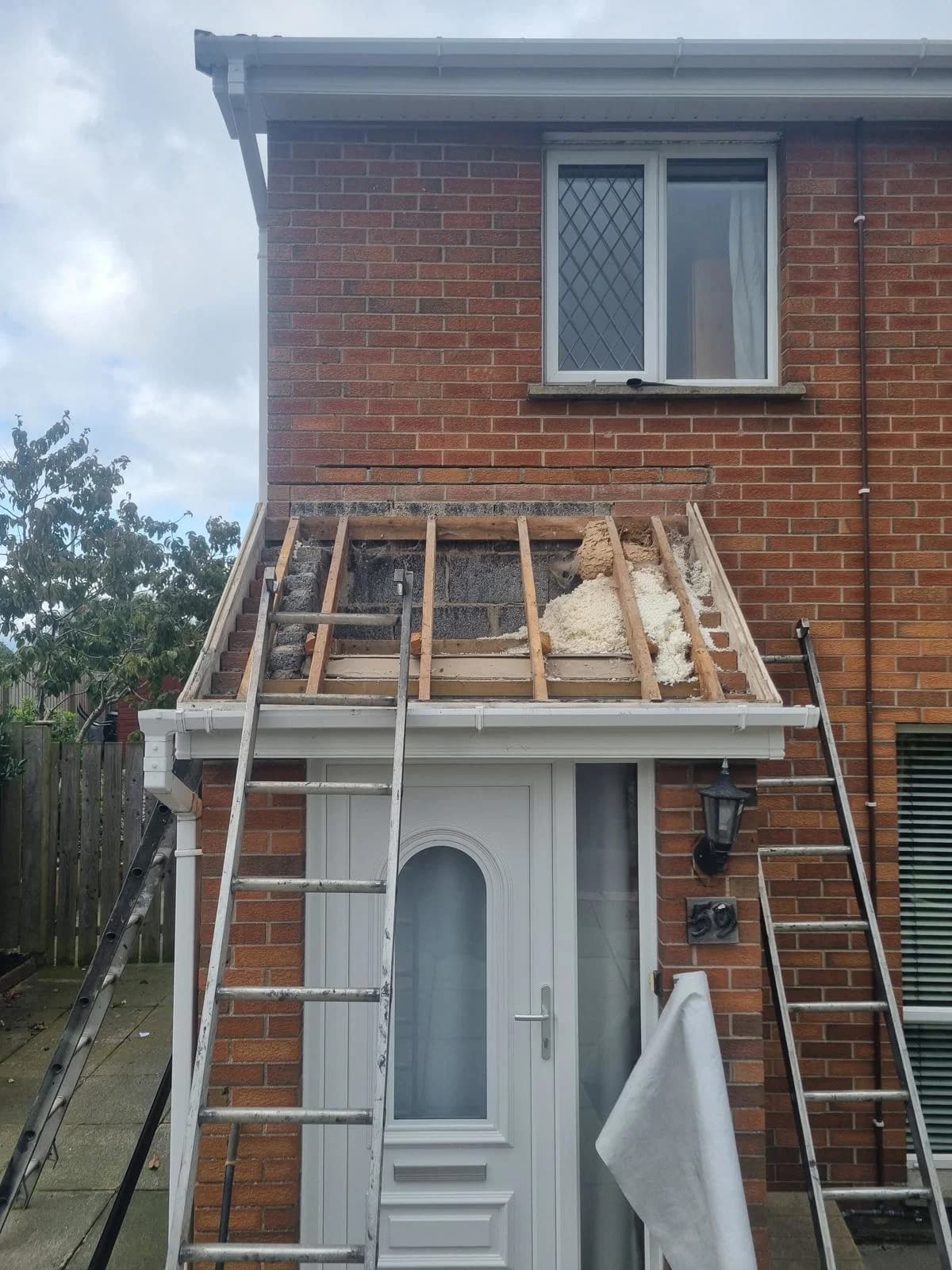 Roof before re-tiling, with insulation exposed during repair