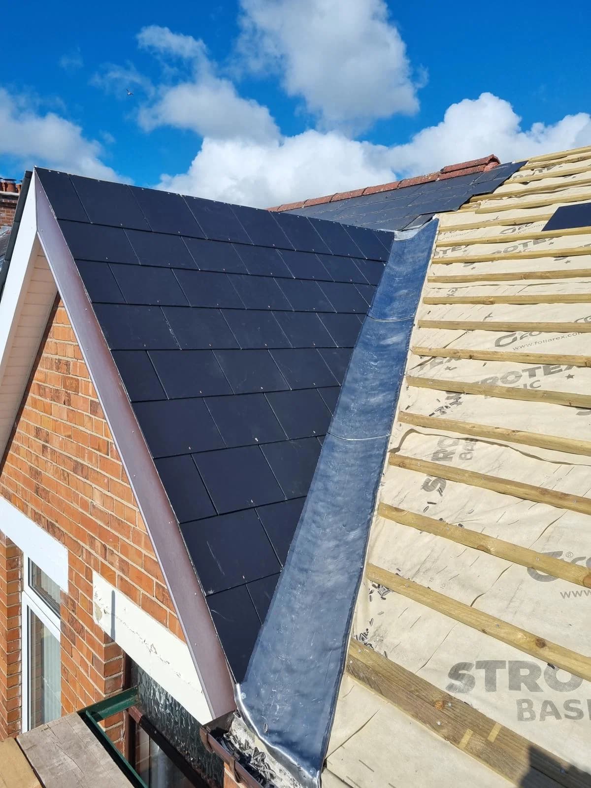 Detail of new roof tile installation with valley flashing
